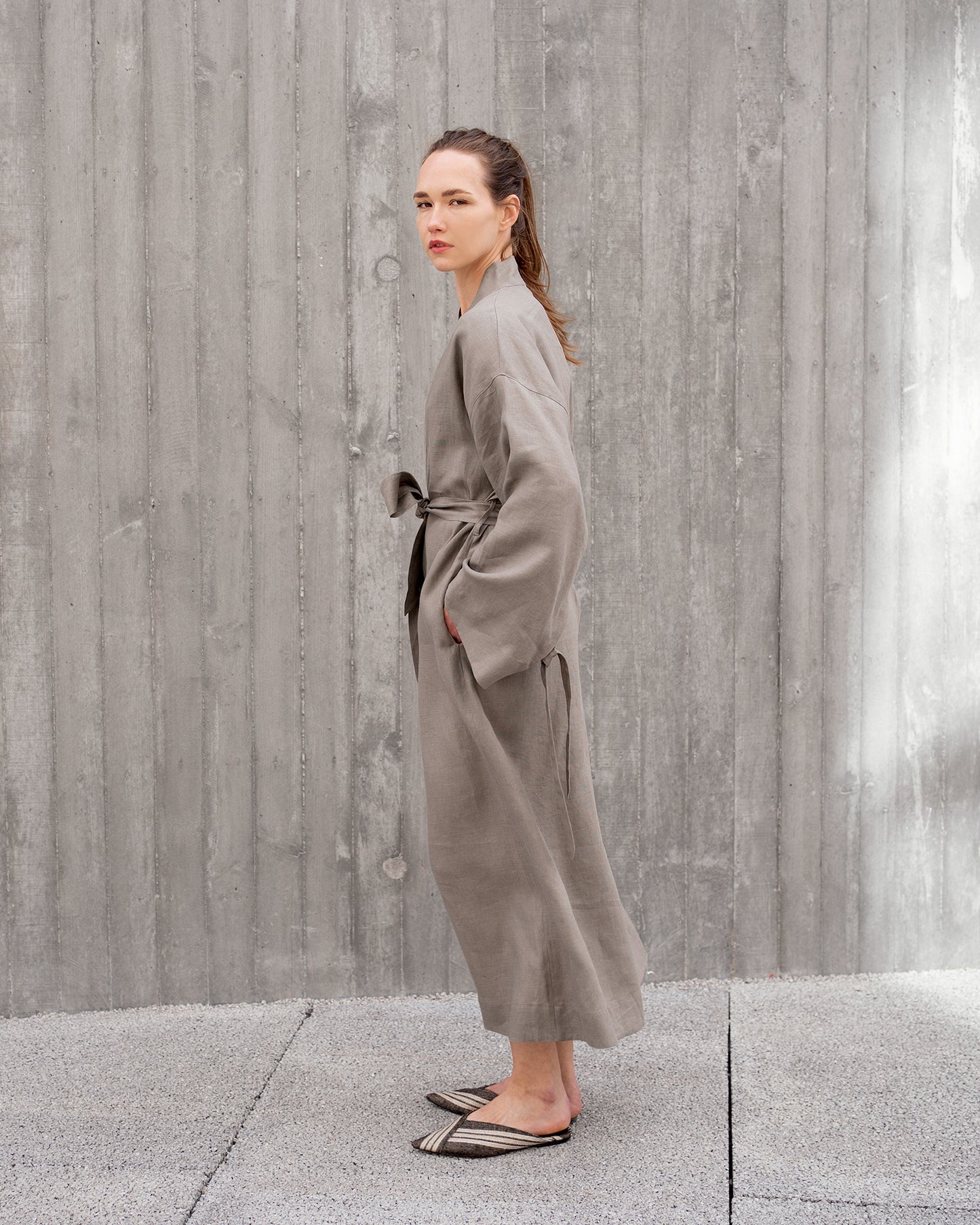 Grey Aiko linen robe by Original Design By KOTA, shown draped on a hanger with soft fabric texture visible.