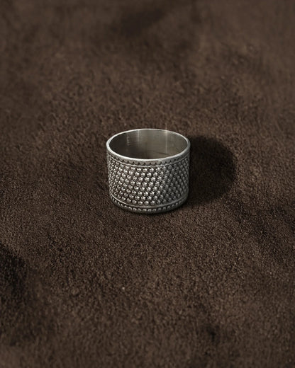 Wide textured silver Band Ring on Brown Background
