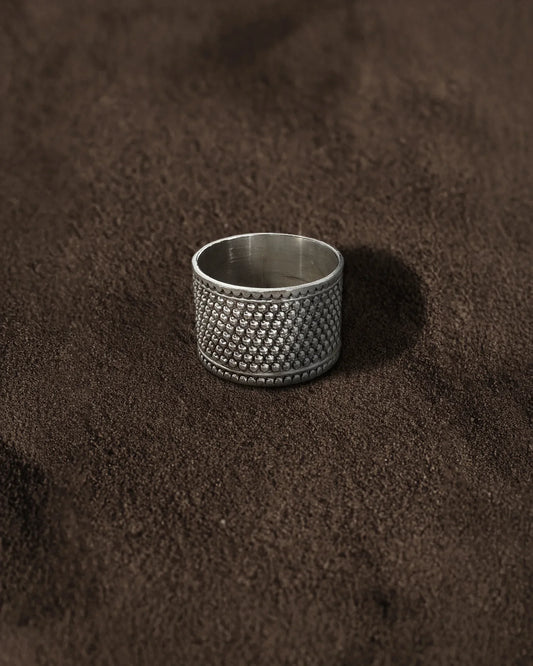 Wide textured silver Band Ring on Brown Background