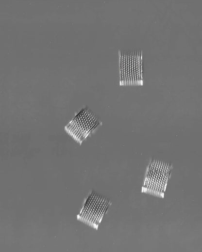 Four Silver Wide band rings on a grey background
